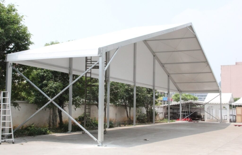 Expansion Screws Fixed: "Expansion screws securely anchoring a tent structure to a concrete surface."